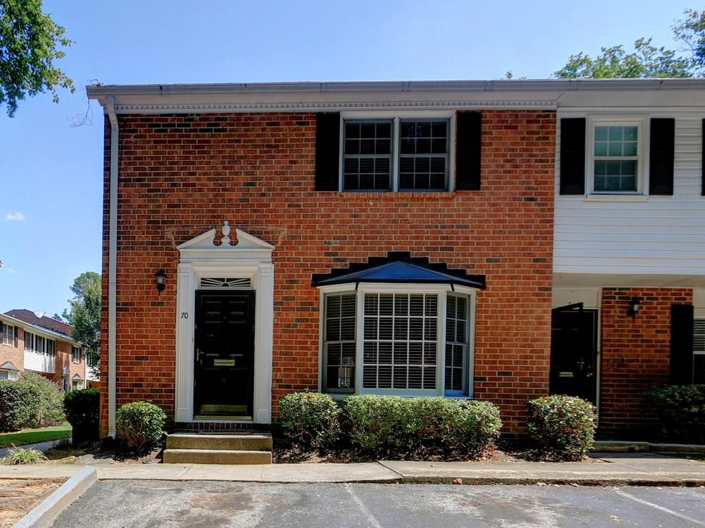 Three sided brick townhome with entry level to main floor. End unit located in back of community overlooking wooded area.