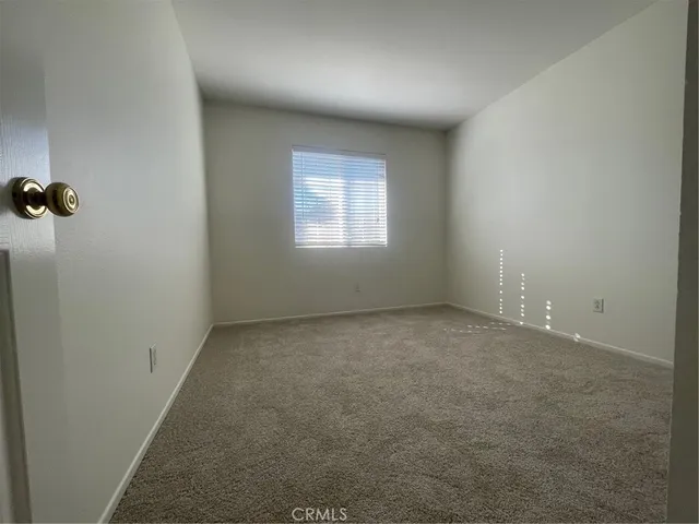 an empty room with a empty space and windows