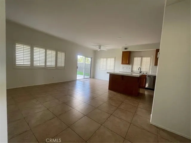 a large white kitchen with a sink and cabinets