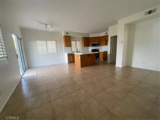 a large white kitchen with a sink and dishwasher a refrigerator with white cabinets