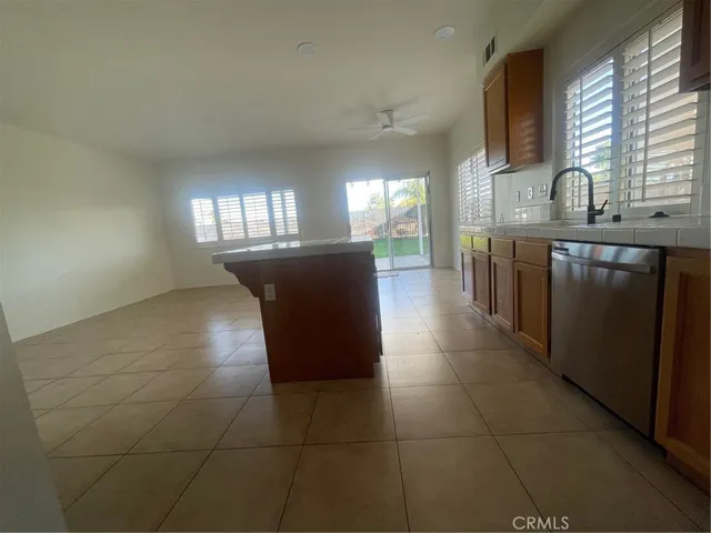 a kitchen with a sink a counter space cabinets and appliances