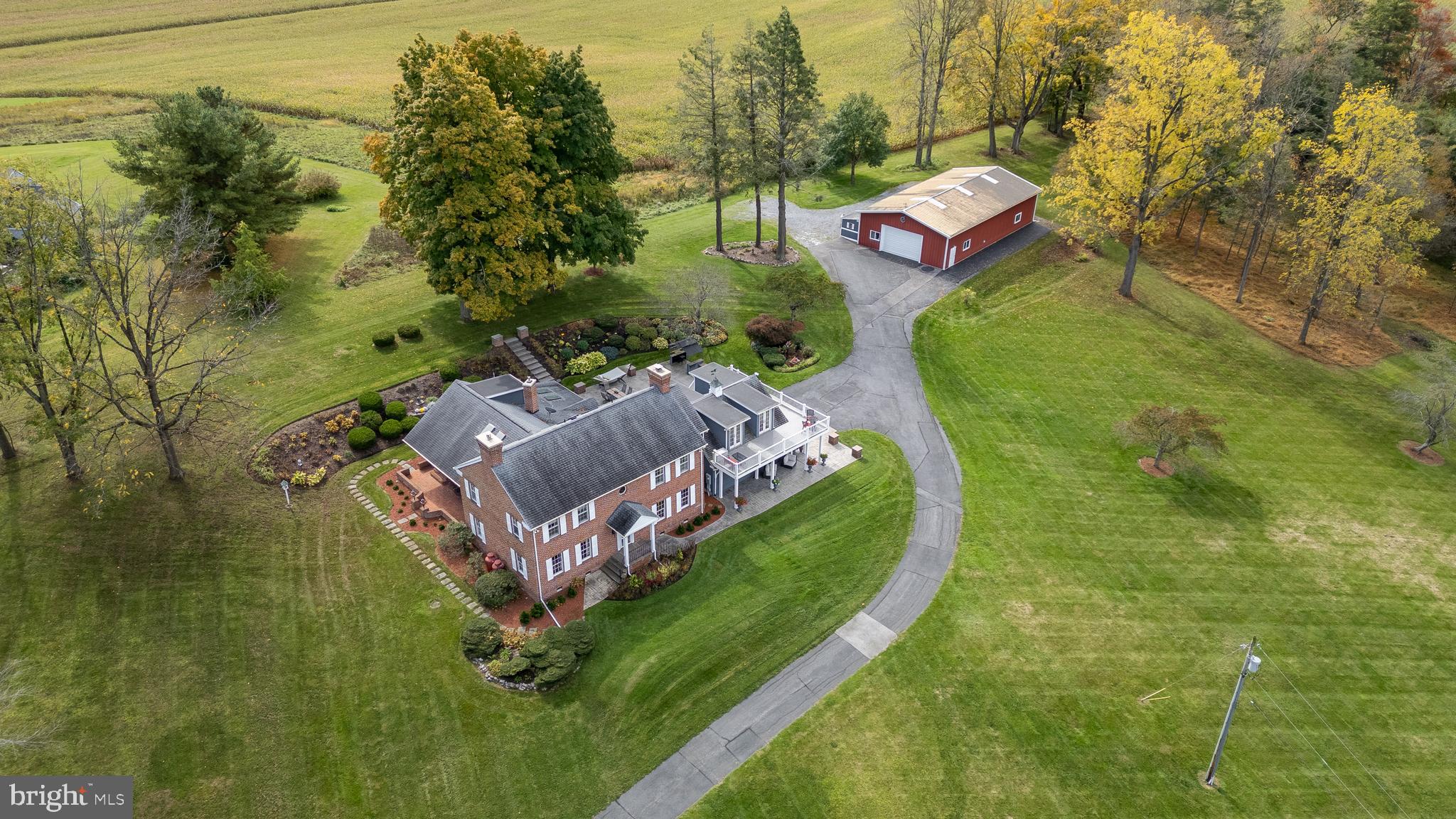 an aerial view of a house with outdoor space pool seating area and yard
