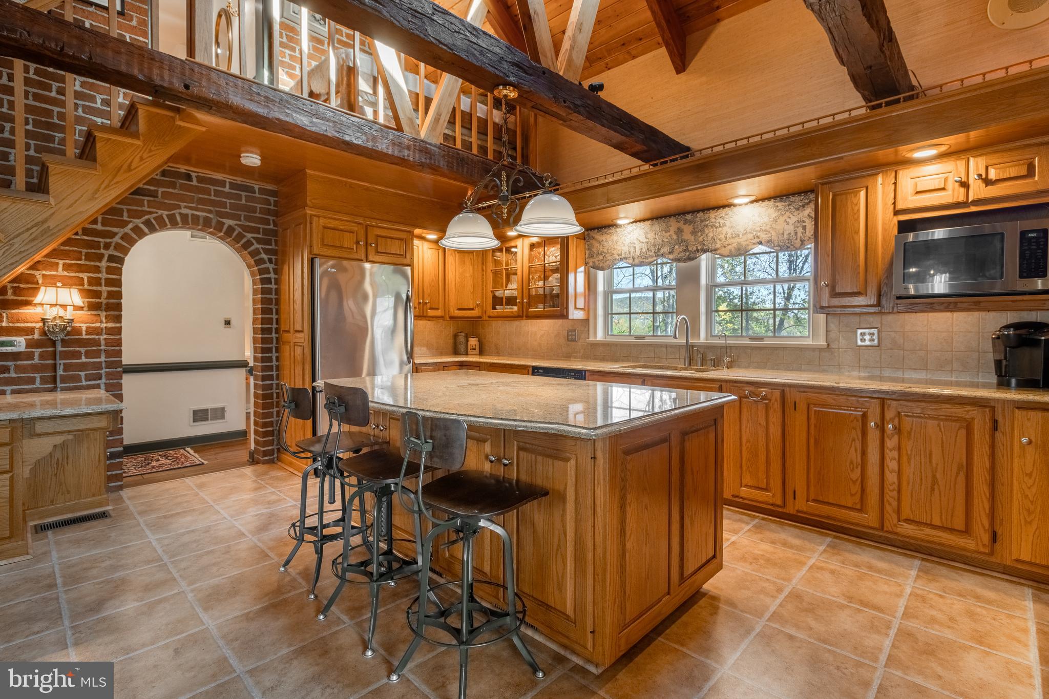 261 Old Fort Road Spring Mills, PA 16875 - Photo 12 of 54 a kitchen with stainless steel appliances granite countertop a sink and a stove