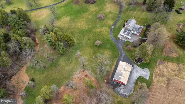 a aerial view of a house with a yard and garden