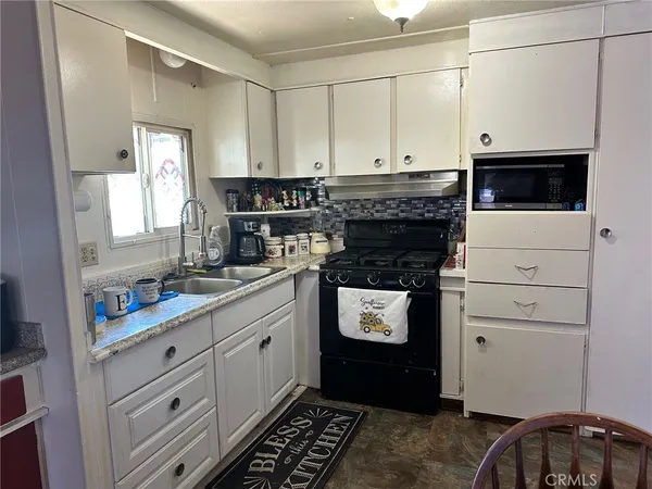 a kitchen with cabinets and appliances