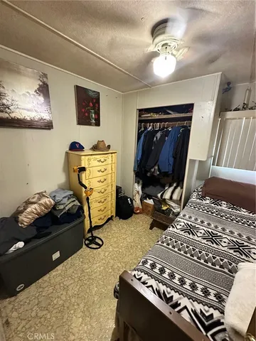 a bedroom with furniture and a mirror