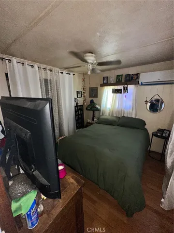 a bed room with a bed and a television