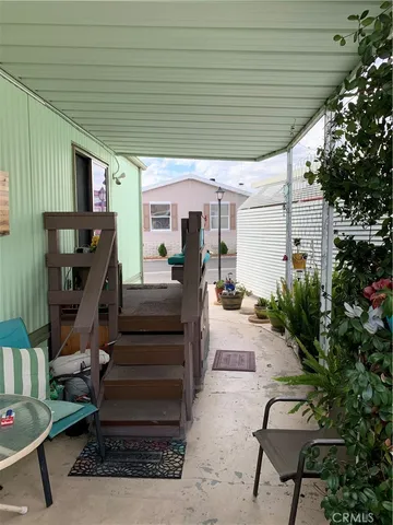 a view of a patio with chairs and a potted plant