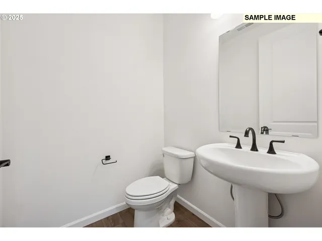 a bathroom with a sink a toilet and mirror