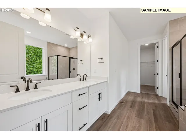 a bathroom with a double vanity sink a mirror a window and a shower