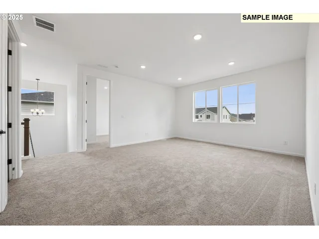 a view of an empty room with a kitchen