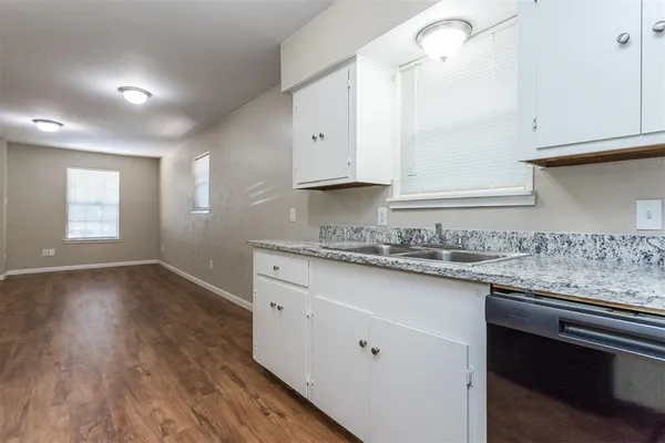 a kitchen with granite countertop a stove and a sink