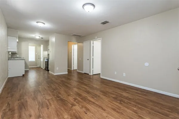 a view of a kitchen cabinets and wooden floor