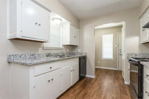 a kitchen with granite countertop a sink and a stove