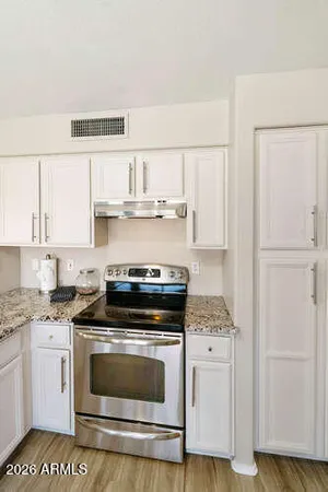 a kitchen with cabinets and appliances