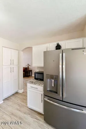 a kitchen with stainless steel appliances a refrigerator and a cabinets