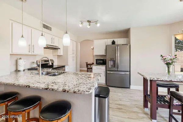 a kitchen with a refrigerator and a stove top oven