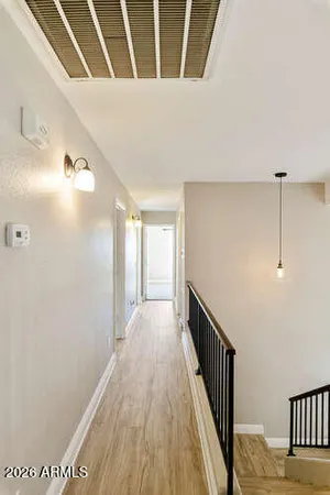 a view of a hallway with wooden floor