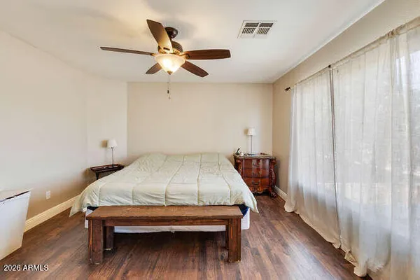 a bedroom with a bed and a chandelier