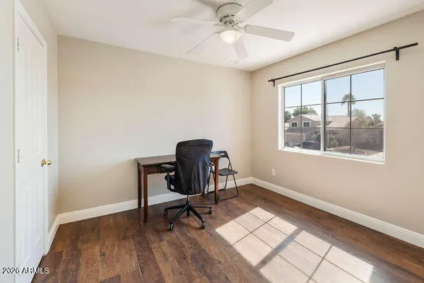 a workspace with wooden floor and a window