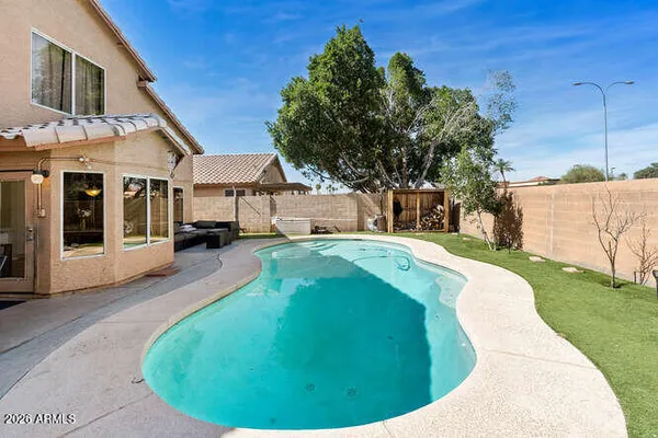 a view of a house with a backyard porch and sitting area
