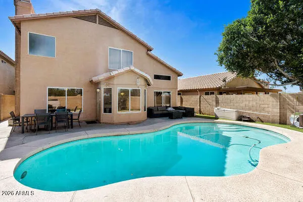 a view of a house with swimming pool and sitting area