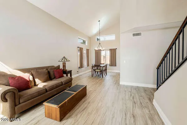 a living room with furniture and wooden floor