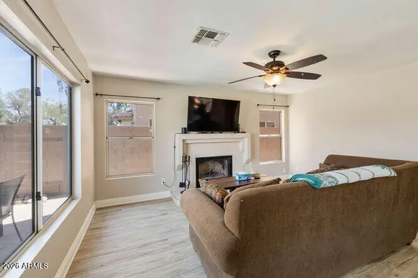 a living room with furniture a fireplace and a flat screen tv