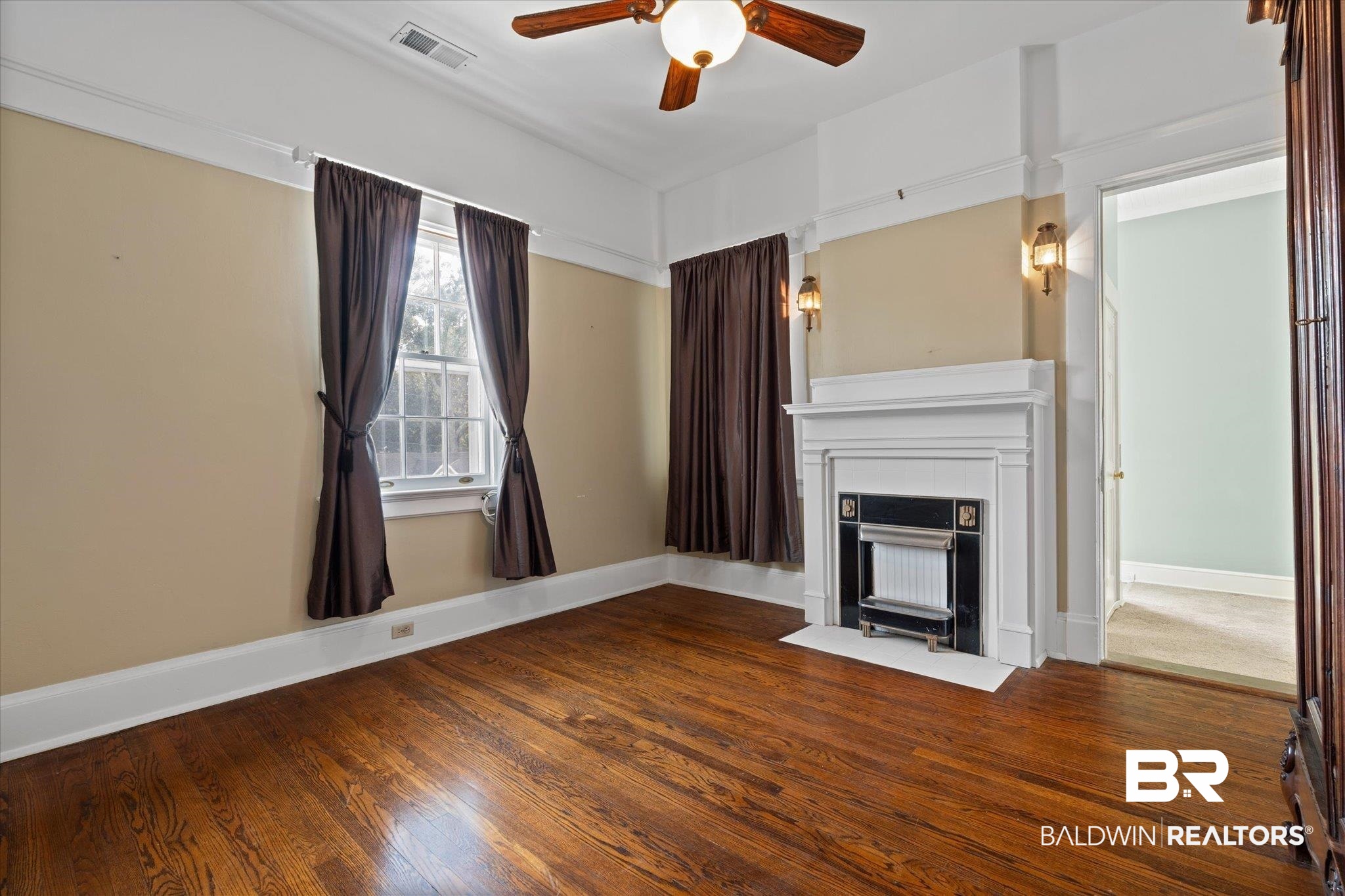 1953 Dauphin Street Mobile, AL 36606 - Photo 25 of 56 Unfurnished living room featuring wood-type flooring and ceiling fan