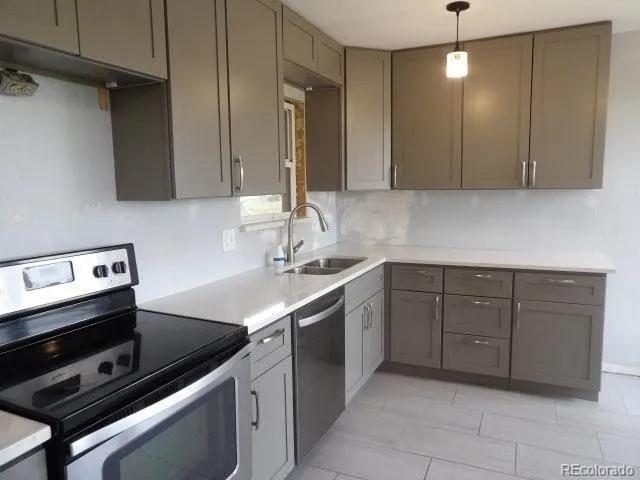 a kitchen with a sink cabinets and appliances