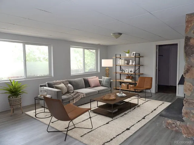 a view of a livingroom with wooden floor and a fireplace