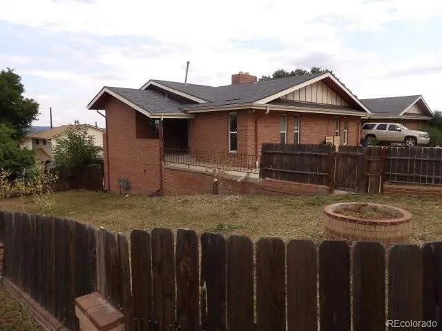 a view of a house with wooden fence
