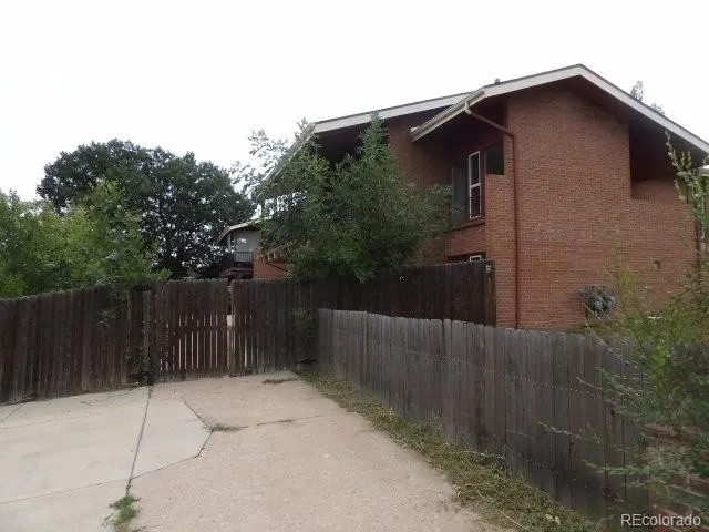 an empty room with wooden floor and fireplace