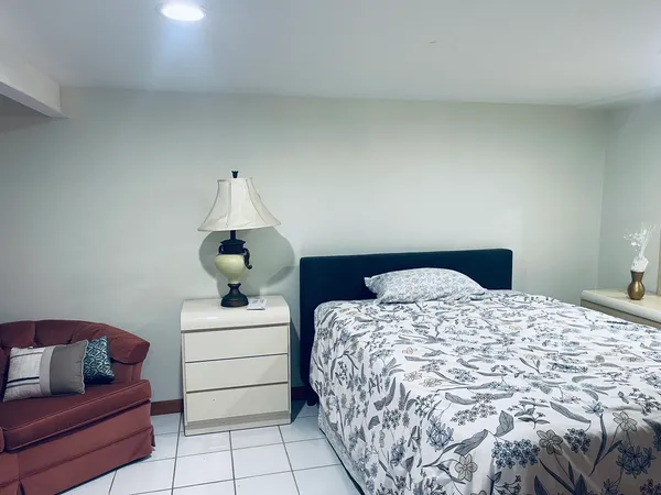 a bedroom with a bed and dresser