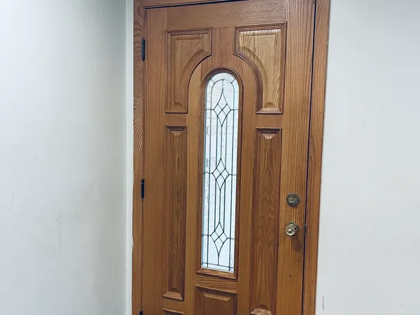 a view of front door with wooden door
