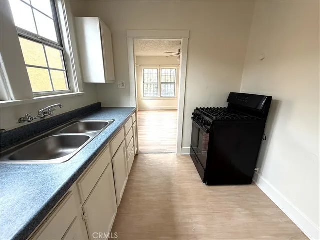 a kitchen that has a sink and a stove