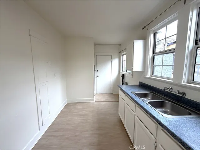 a kitchen with granite countertop a sink and cabinets