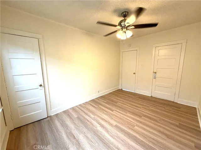 a view of a ceiling fan and wooden floor