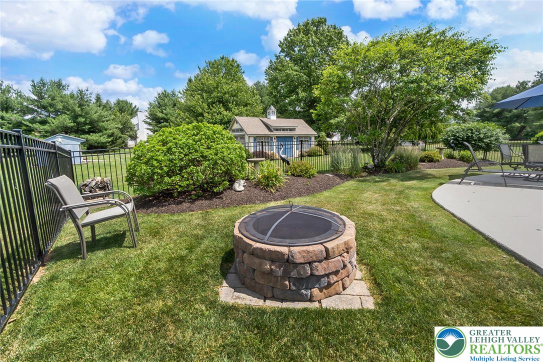 1795 Freier Road Quakertown, PA 18951 - Photo 50 of 69 A private, fenced backyard oasis with a stone fire pit and a charming shed.