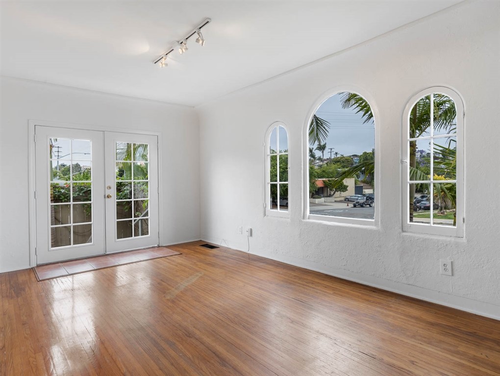 1980 Chatsworth Boulevard San Diego, CA 92107 - Photo 13 of 21 a view of an empty room with a window and wooden floor