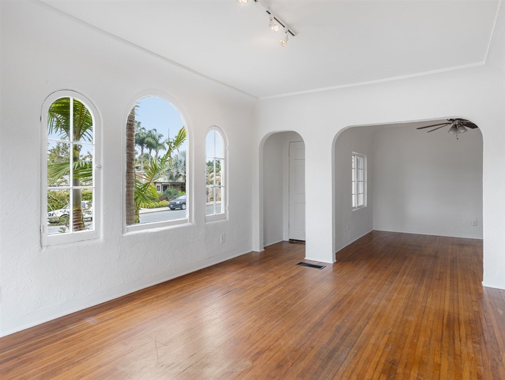 1980 Chatsworth Boulevard San Diego, CA 92107 - Photo 14 of 21 a view of an empty room with glass door and wooden floor