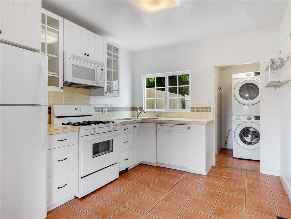 1980 Chatsworth Boulevard San Diego, CA 92107 - Photo 15 of 21 a kitchen with stainless steel appliances granite countertop a stove a sink and a microwave