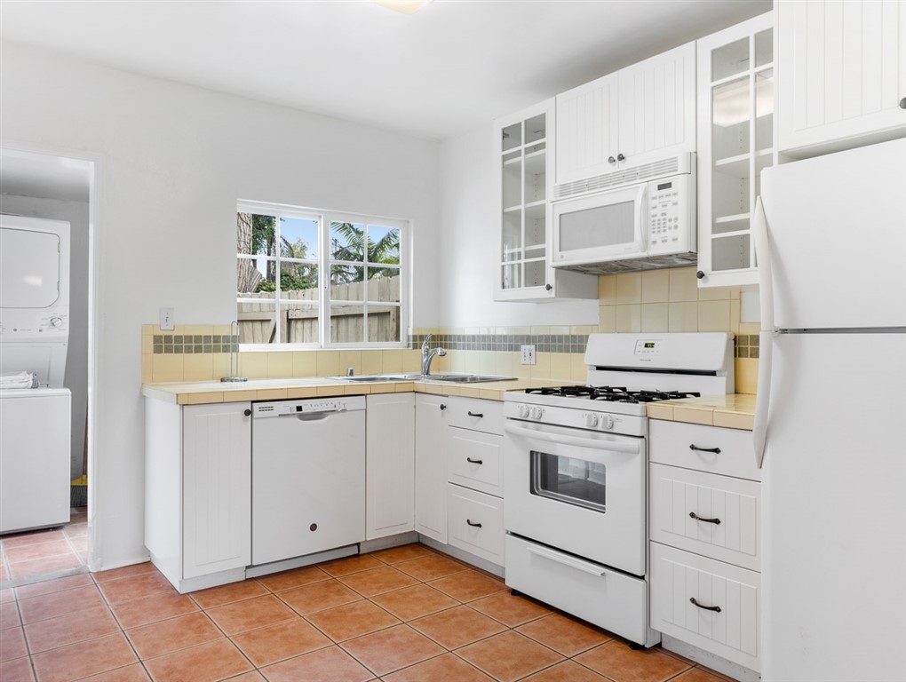 1980 Chatsworth Boulevard San Diego, CA 92107 - Photo 8 of 21 a kitchen with granite countertop white cabinets and white appliances