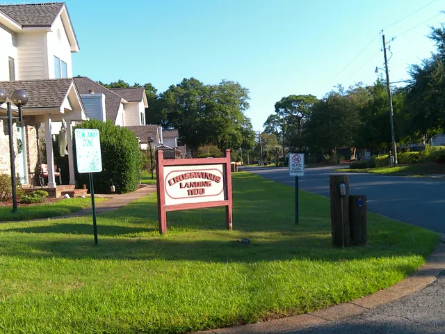 a sign that is sitting on the grass and the grass