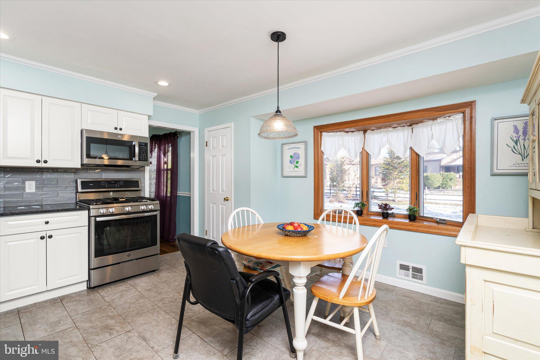 8 Wayne Way East Windsor, NJ 08520 - Photo 11 of 29 a kitchen with a dining table chairs and refrigerator