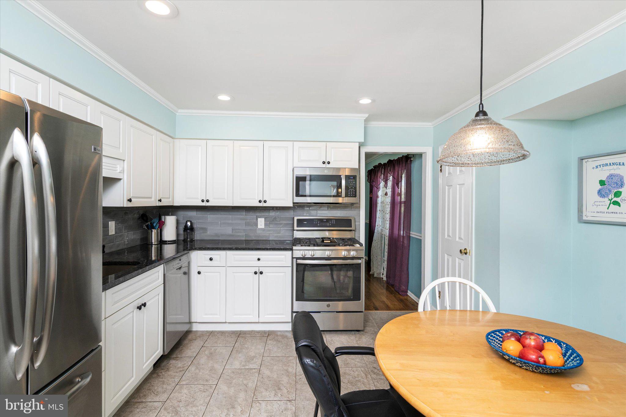 8 Wayne Way East Windsor, NJ 08520 - Photo 12 of 29 a kitchen with stainless steel appliances granite countertop a refrigerator a stove a sink dishwasher and a refrigerator