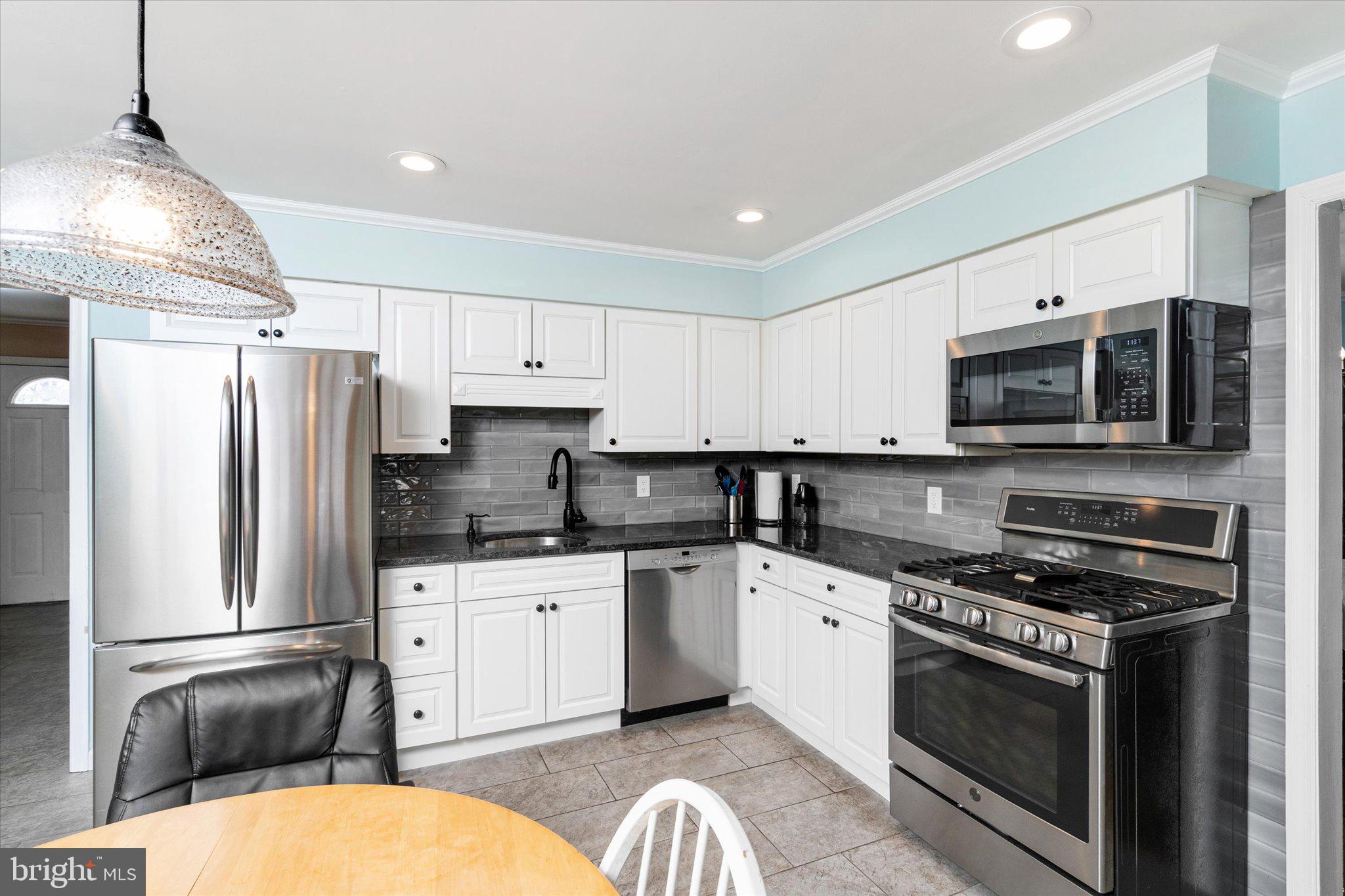 8 Wayne Way East Windsor, NJ 08520 - Photo 13 of 29 a kitchen with stainless steel appliances a stove a sink dishwasher a refrigerator microwave and cabinets