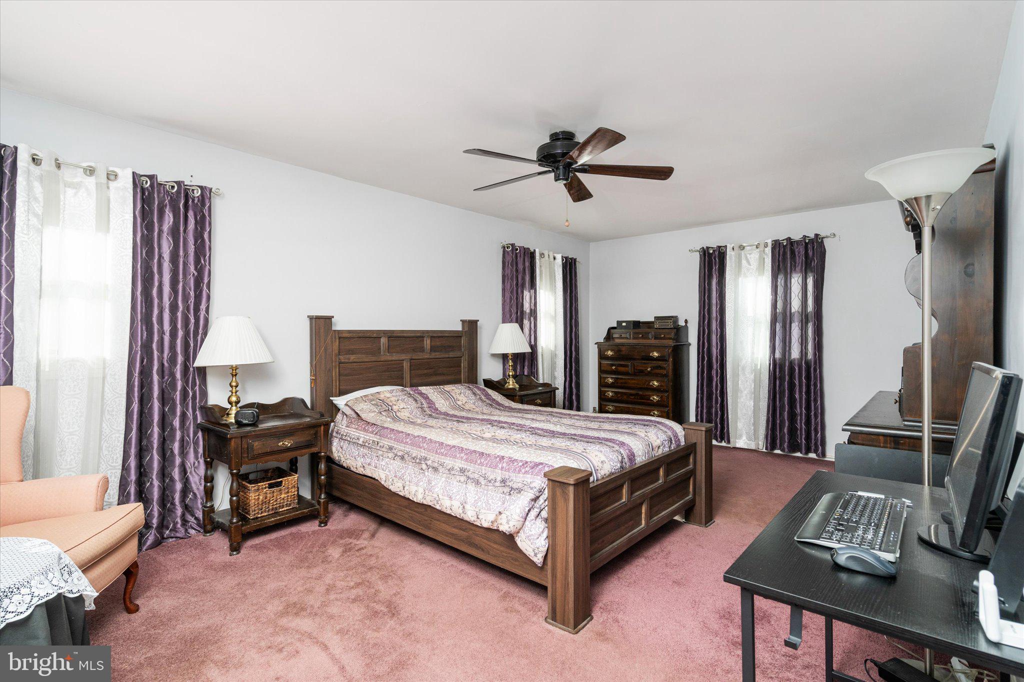 8 Wayne Way East Windsor, NJ 08520 - Photo 23 of 29 a bedroom with a bed a dresser and a chandelier