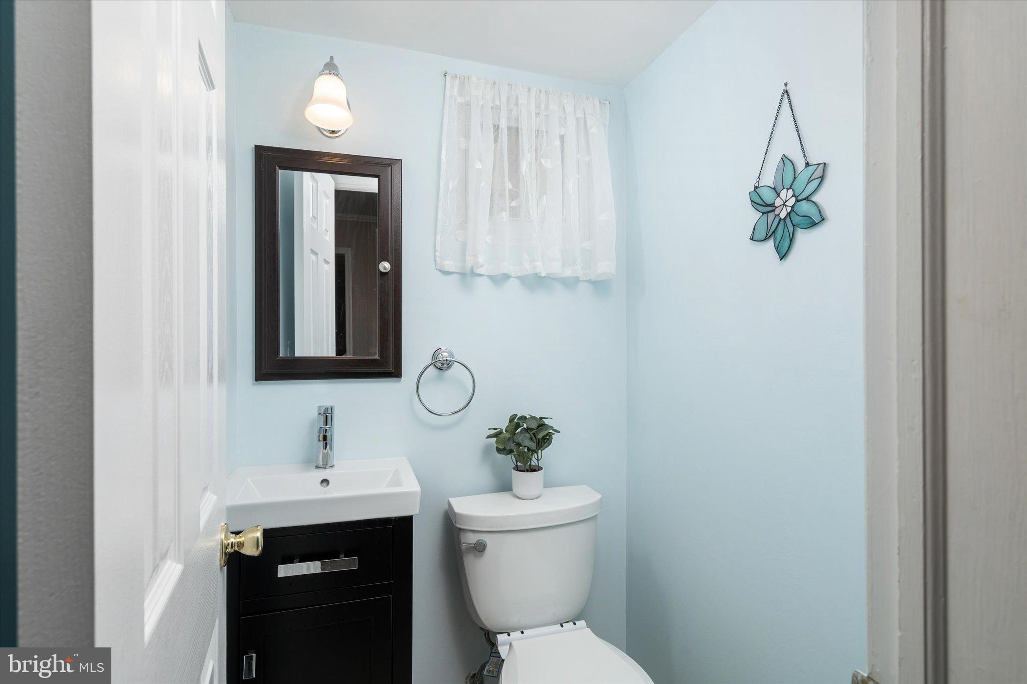 8 Wayne Way East Windsor, NJ 08520 - Photo 10 of 29 a bathroom with a toilet a sink and mirror