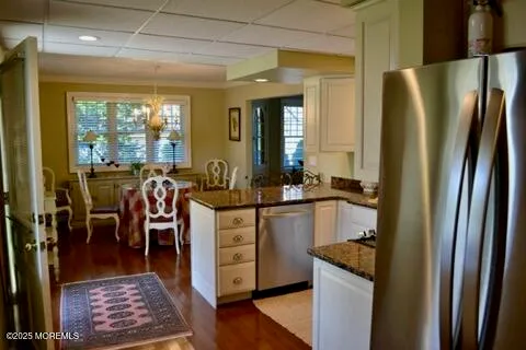 a kitchen with sink refrigerator and window
